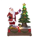 Joulupukki koristelemassa joulukuusta